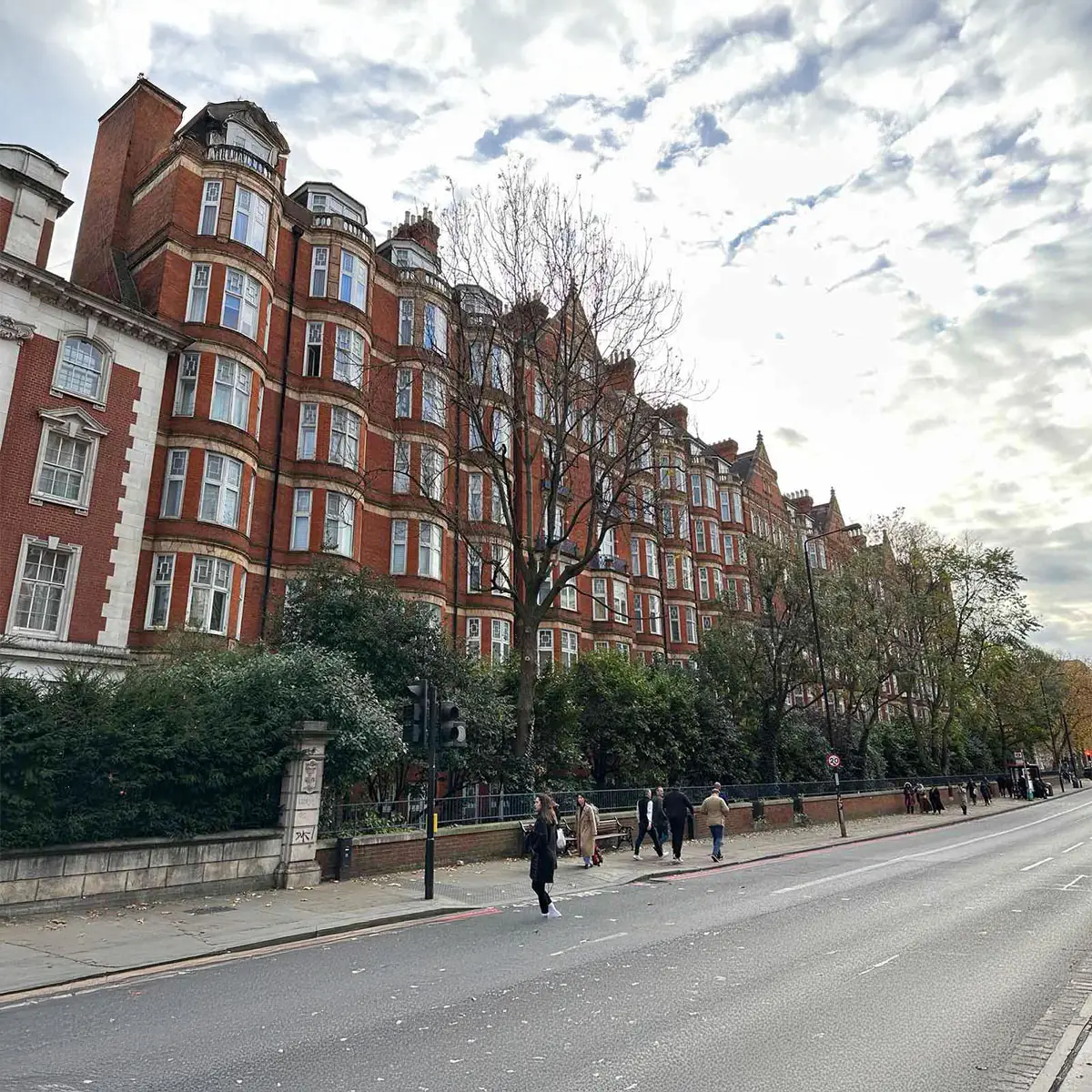 Red-brick mansion blocks along a tree-lined street in Marylebone