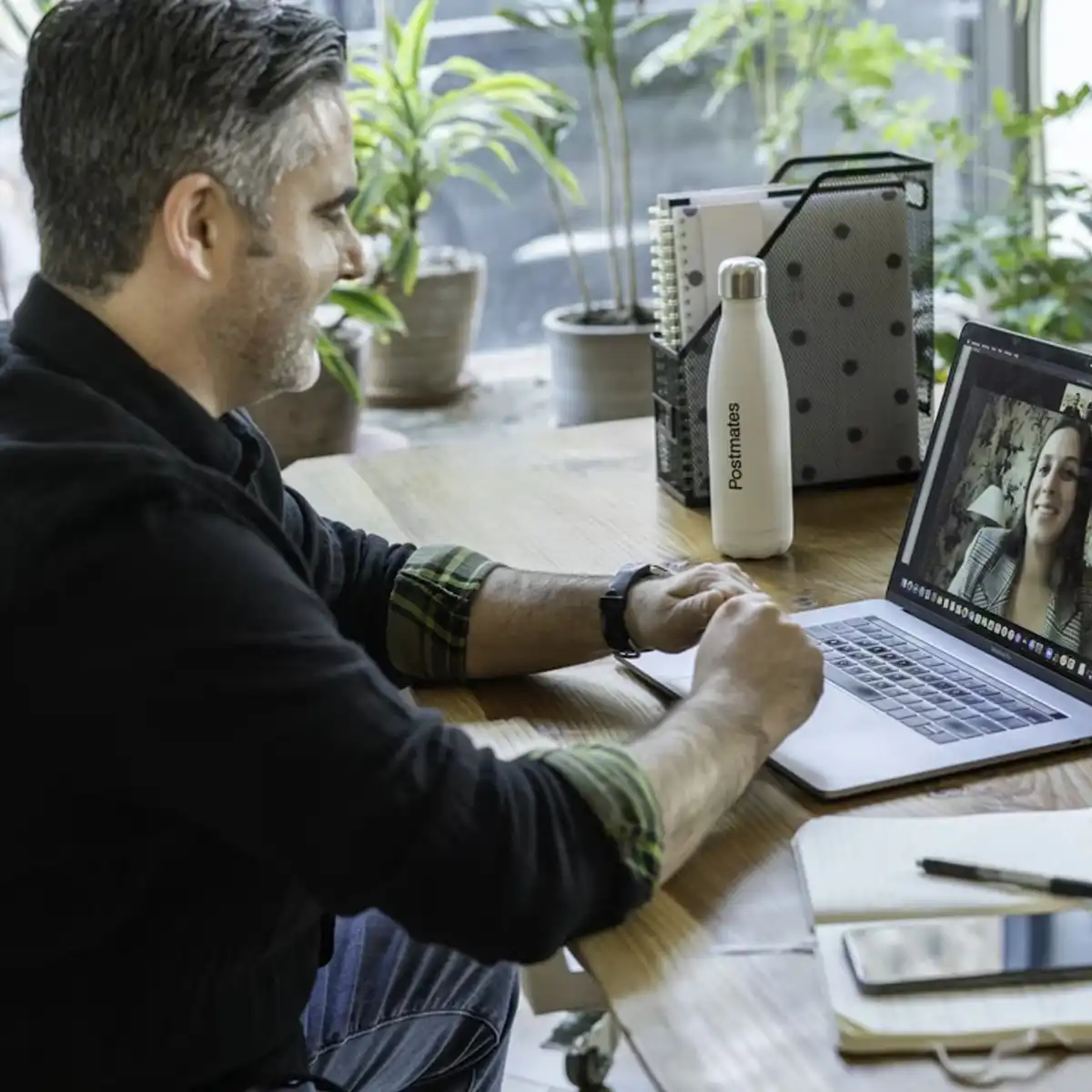 A patient speaking with a clinician by video call on a laptop during an online consultation