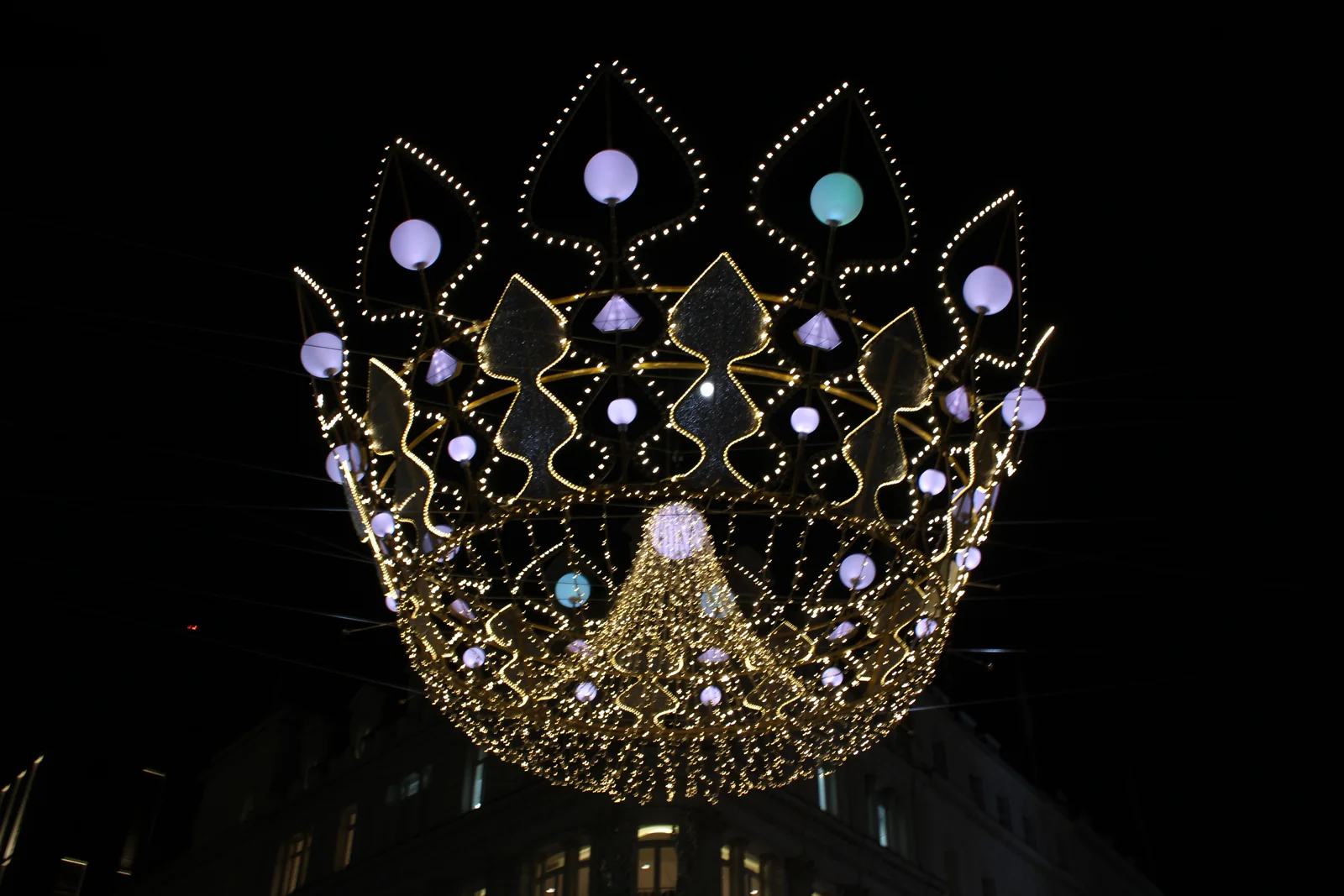 Jewelled crown Christmas light suspended above New Bond Street, Mayfair