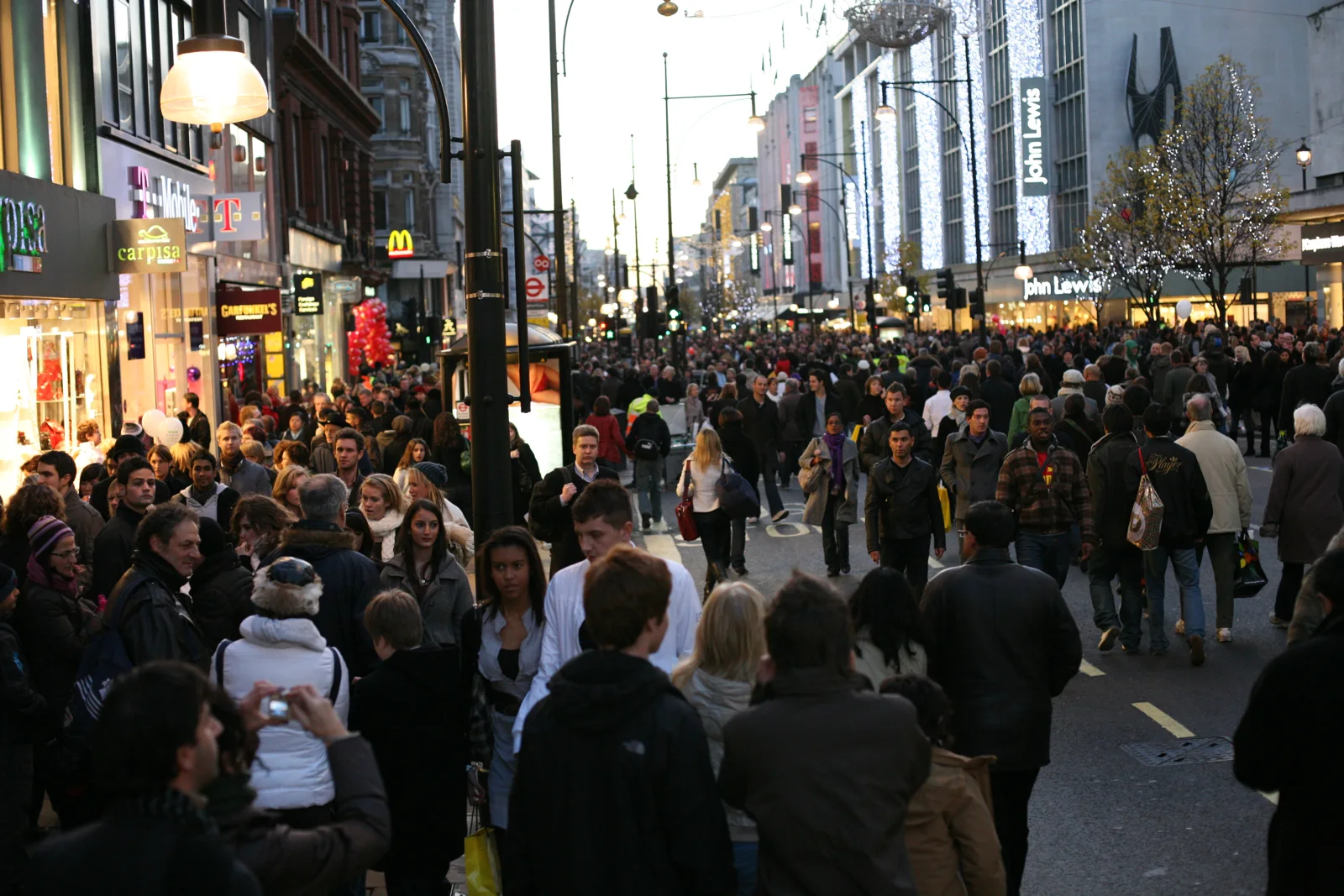 Crowds filling the whole width of Oxford Street on a traffic-free shopping day in December 2008